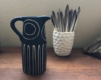 Black Pitcher with devised white geometric design