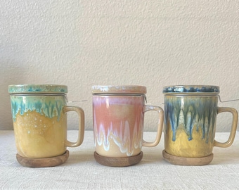 Hand painted tea mug holds 10oz with strainer, lid & saucer. Each will vary 3 different styles.