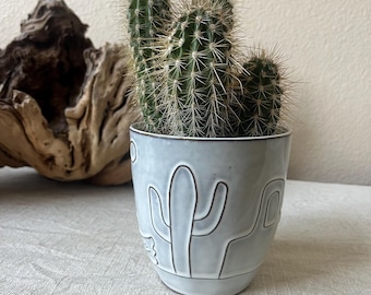 white and brown planter with a reactive glazed desert scene. No drain whole