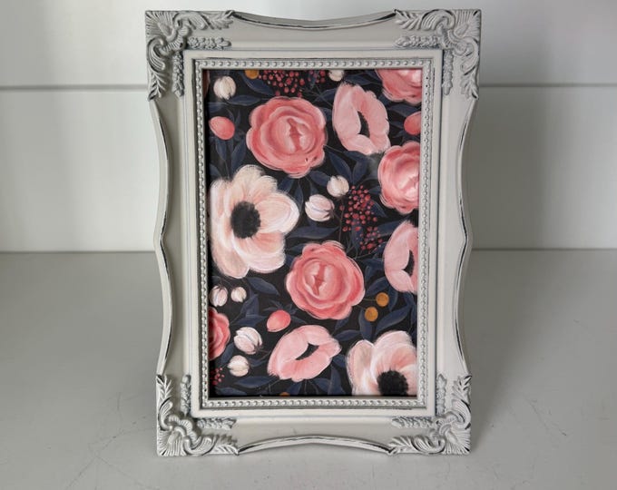 Vintage white 5 1/2"x 7 1/2" frame with victorian style detailing holds a 3 1/2"x 5 1/2" image