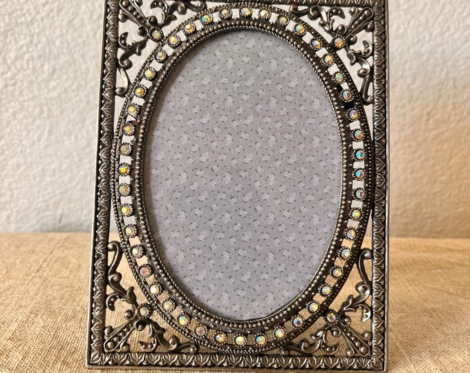Vintage Art Deco style 6 1/2"x5"  silver frame with rhinestone detail with oval window holds a 3 1/4" x 5 " image