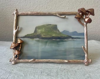 Gold enameled frame 7" x 5" with mushroom and branch details hold a 4x6 image