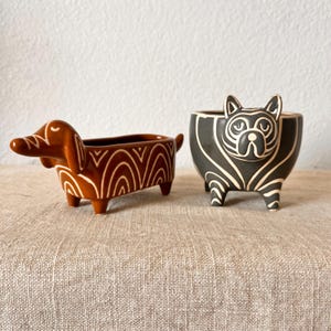 Cat and dog ceramic planter with stripes holds a 2-3 inch plant. Sold separately.