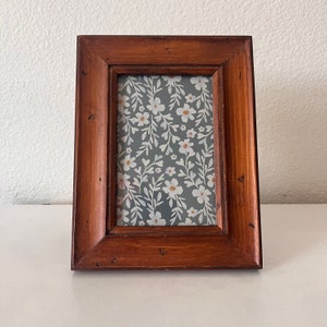Wood 6 1/2 x 8 3/4 inch frame hold approximately a 3 1/2 x5 1/2 image.