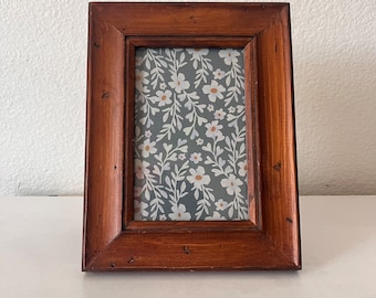 Wood 6 1/2 x 8 3/4 inch frame hold approximately a 3 1/2 x5 1/2 image.