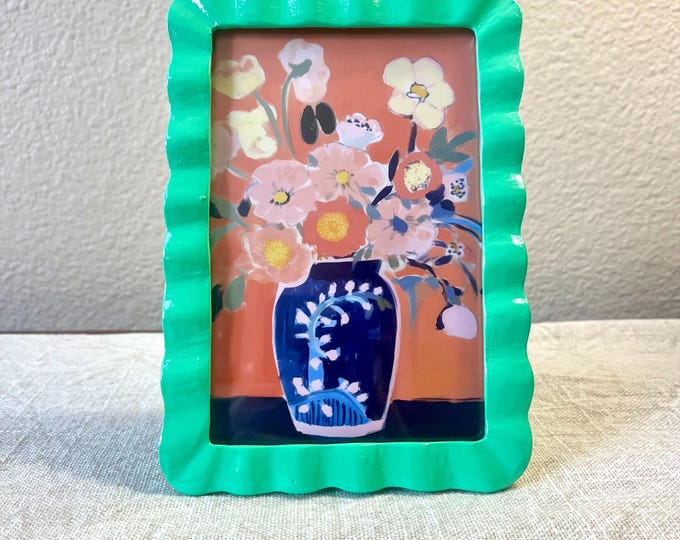 Vintage style green 6 3/4”x 4 3/4” resin frame holds a 3 1/2”x 5 1/2” photo