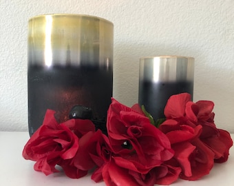 This elegant candles is a gold and black layered frosted glass hurricane.The large is 8”x5” and the small is 6”x 3 1/2”.