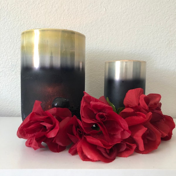This elegant candles is a gold and black layered frosted glass hurricane.The large is 8”x5” and the small is 6”x 3 1/2”.