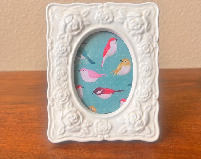 Vintage 5"x4" white frame with rose details and oval window holds a  2x3 image. Stand only