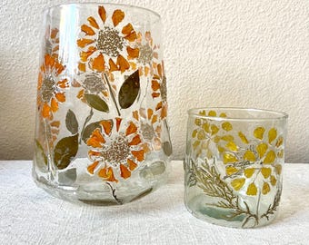 Glass candle holder debossed with leaf and petals in flower pattern