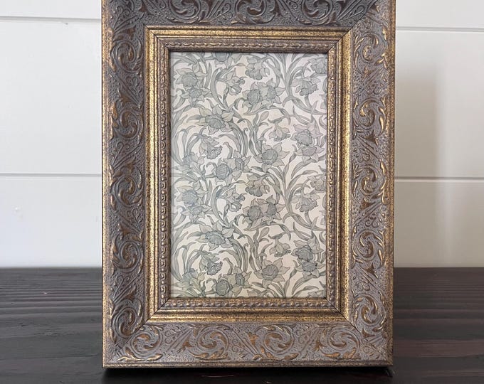Vintage 8 1/4"x 6 1/4"gold frame with ornate etched detailing holds approximately a 3 1/2" x 5 1/2" image.