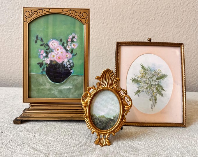 Victorian style 7 1/2x 5 brass picture frame holds a 3 1/2"x5 1/2" image