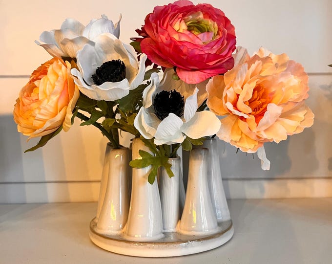 White mod bud vase with 12 openings 5 1/4"D" x 3 1/2" H