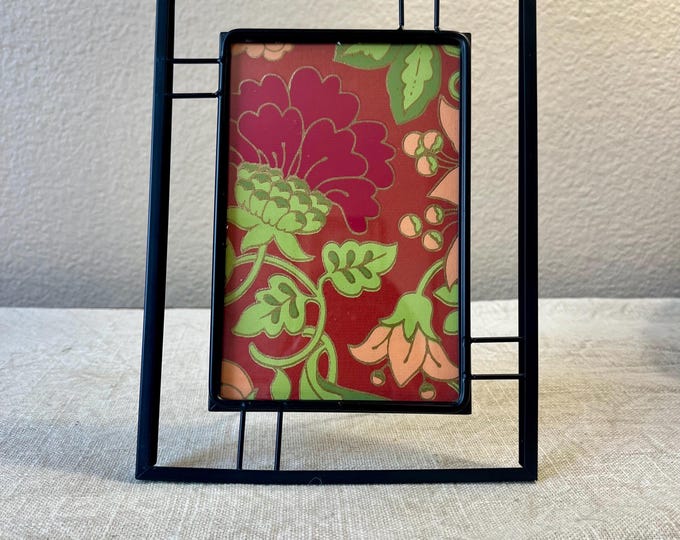 Vintage black metal 8x6 inch frame with ornate details holds a 4"x6" image.