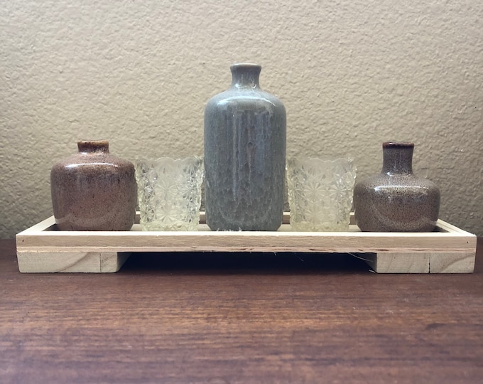 Vintage glass votives and vases on wood tray