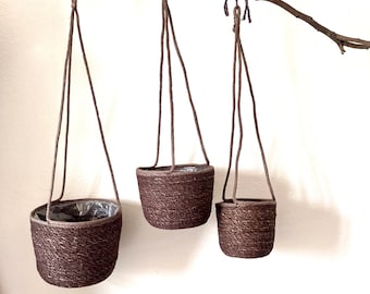 Charcoal gray hanging hand woven sea grass basket planters with plastic liner available in 3 sizes holds a 5 inch, 6 inch, 8 inch