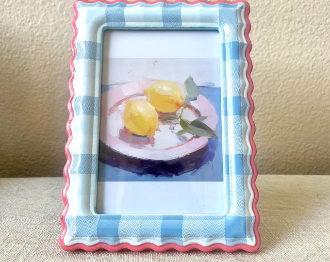 Vintage style blue plaid frame with pink scalloped edge 5 1/2x 7 1/2 holds a 3 1/2x 51/2 inch image.