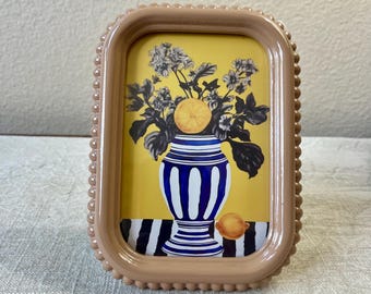 Vintage style tan 7”x 5” resin frame holds a 4”x 6” photo