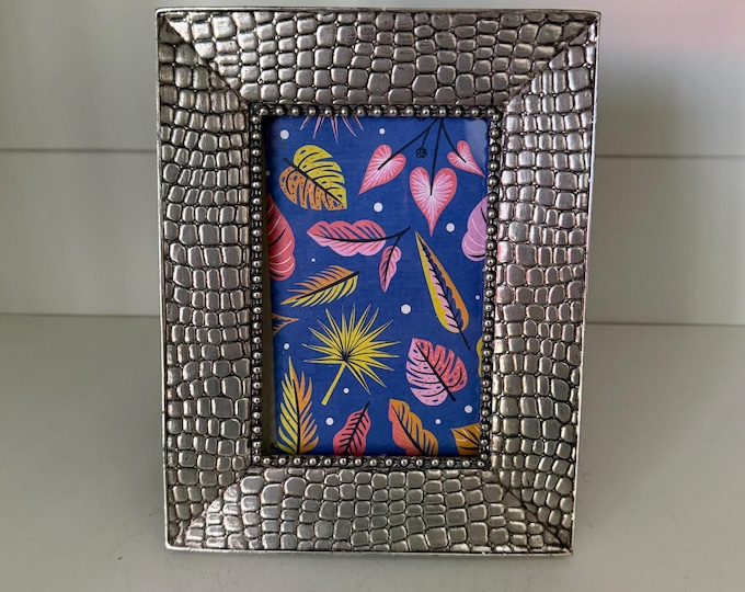 Vintage 7"x 9" silver frame with scaly pattern holds a 3 1/2"x 5 1/2" image