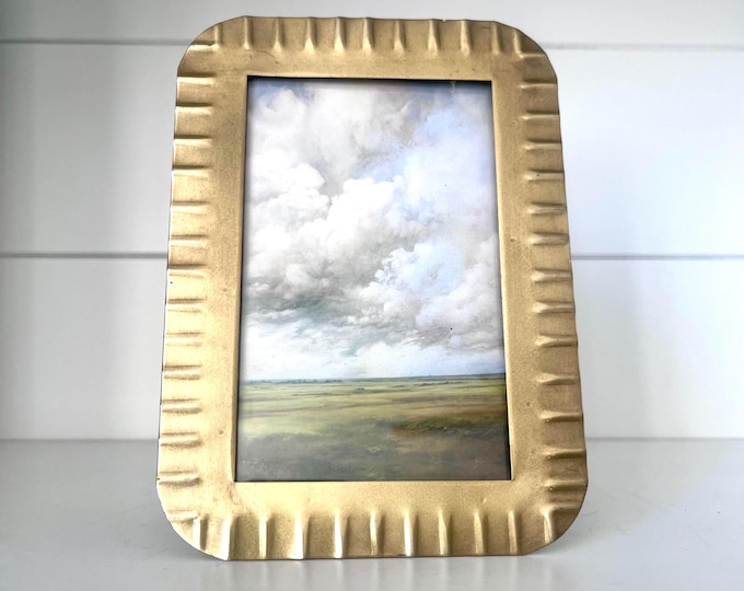 Vintage 5"x7" brass frame holds a  3 1/4" x 5 1/4" image.