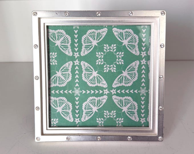 Vintage silver 5 1/4” x 5 1/2” frame holds a a 4 1/2”x4 1/2” photo