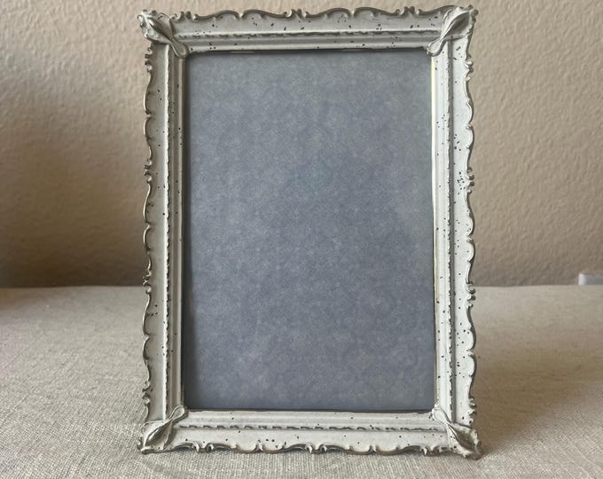Vintage silver 6x 8 white brass frame holds a 4 1/2" x 6 1/2" image