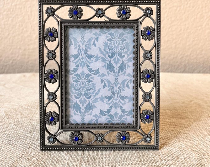 Vintage pewter frame 4"x5" frame with blue rhinestone and flower  details holds approximately a  2 1/2"x 3 1/2" image