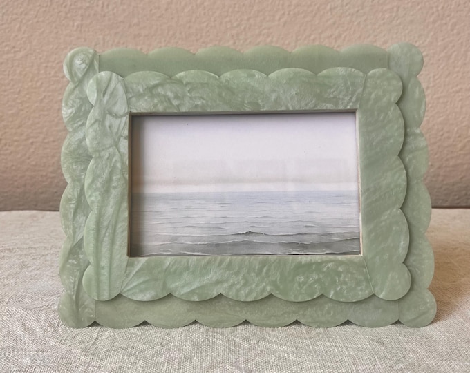 Resin 6 3/4"x 8 3/4" frame with scallop edge holds a 3 1/2"x 5 1/2" image. 3 colors available sage, indigo, and saffron