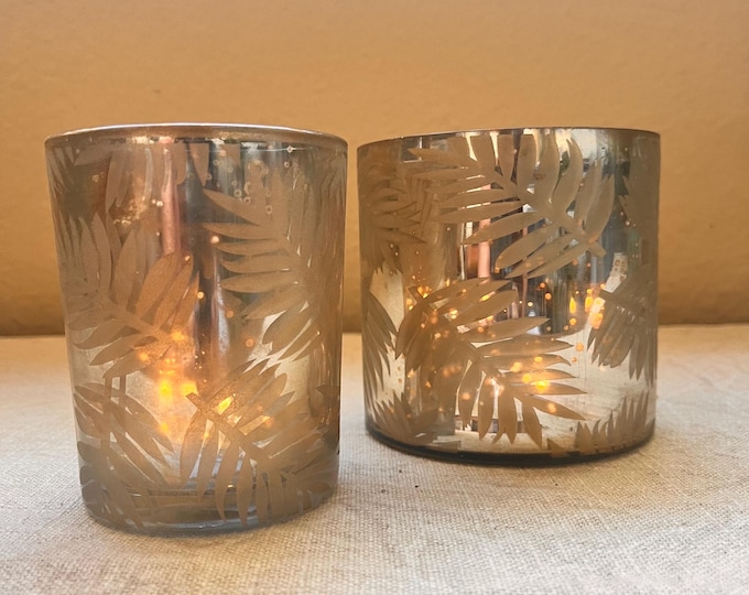 Gold mercury glass candle with leaf and snow motif comes in 2 sizes 4”x4” or 3”x4”