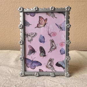 Vintage silver 5 1/2 x 7 1/2 frame holds a 4 1/2&quot; x 6 1/2&quot; image detailed with flowers and rhinestones