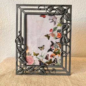 Vintage silver 9&quot; x 7&quot; frame with leaf detailing holds a 5&quot;x 6 1/2&quot; image