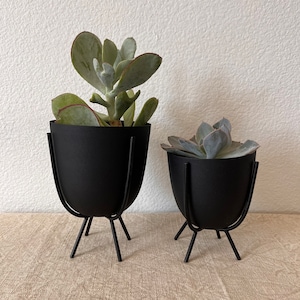 black matte metal planter with footed stand comes in 2 sizes