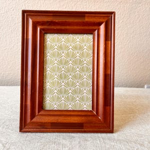 Wood 6 1/2 x 8 3/4 inch frame hold approximately a 3 1/2 x5 1/2 image.