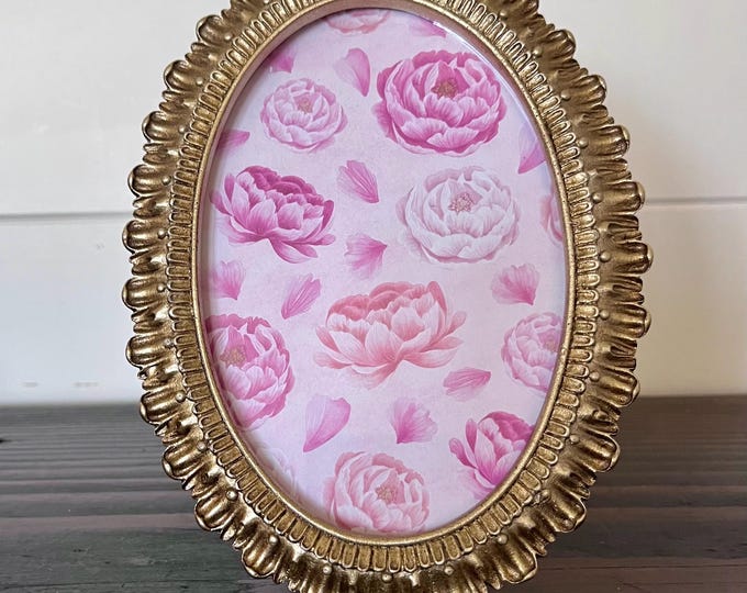 Vintage Victorian style oval gold frame 7”x 5" with ornate etched detailing holds a 3 1/2'x5" image. Stand only