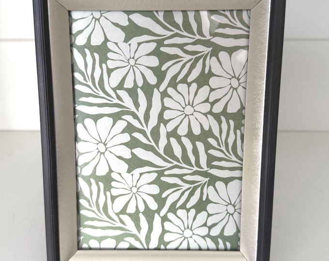 Vintage silver 6"x 8" frame with black border holds a 5"x 7" image