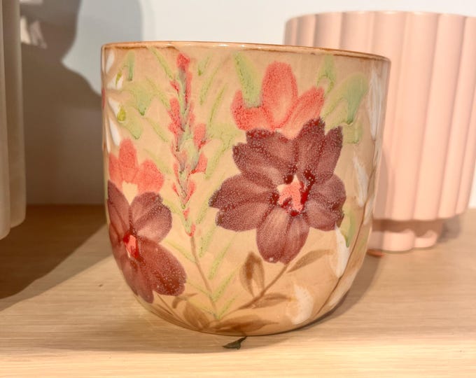 Cream colored planter with floral detail in pink and purple flowers.  5.25"W x4.75"H