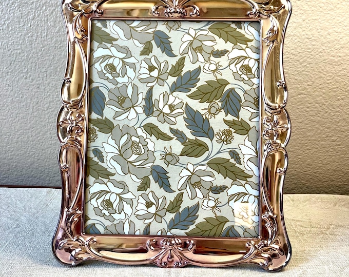 Vintage silver and rose gold toned 8x10 photo frame with ornate detail. Frame measurements are 12 x10 holds a 7 1/2 x 9 1/2” image