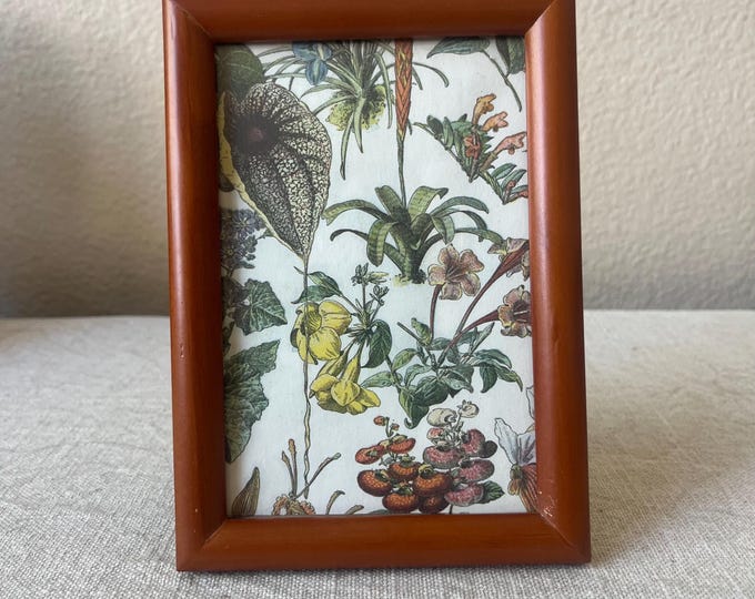 Vintage wood 6 3/4” x 5 3/4" frame with ornate details hold a 3 1/2 x 5 1/2” image