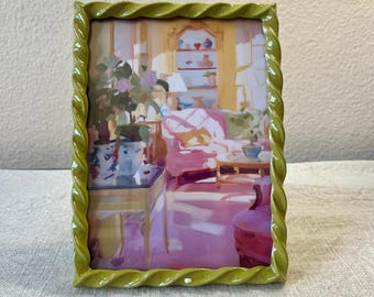 Vintage style olive green 7 1/2”x 5 1/2” resin frame holds a 6 1/2”x 4 1/2” photo
