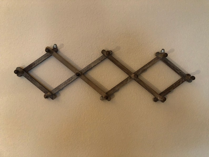Expandable accordion wall hanger with 10 pegs in a distressed Etsy