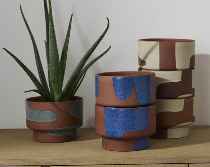Modern terra cotta planter with abstract painting. 7"x 5.25" Comes in three colors