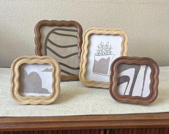Wood frame with scalloped edges comes in two different colors. Can hang and stand both horizontal and vertical.