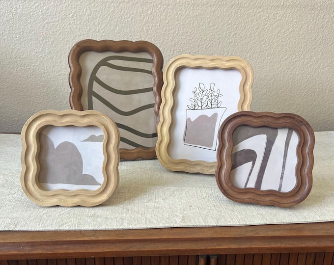 Wood frame with scalloped edges comes in two different colors. Can hang and stand both horizontal and vertical.