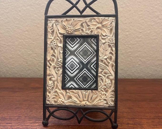 Vintage 3 1/2 " x 6 1 /2" metal frame with flower detail holds a 1 1/2"x 2 1/2" image