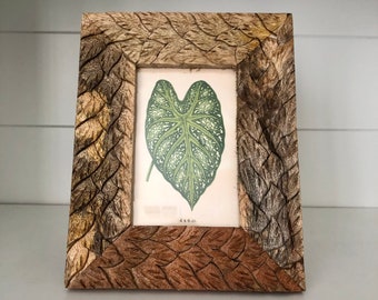 Carved mango wood frame 71/2"x 91/2"  with etched leaf detailing holds 4x6 image. Stand only both horizontal and vertical.