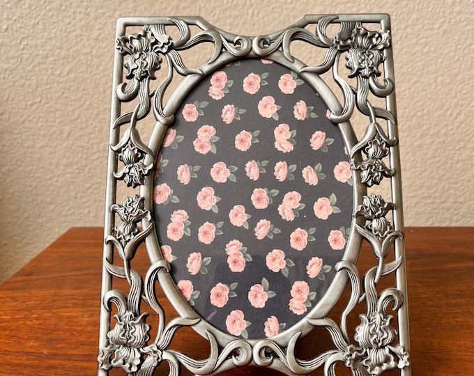 Vintage silver 9x7 photo frame holds a 4 1/2 x6 1/2 image.