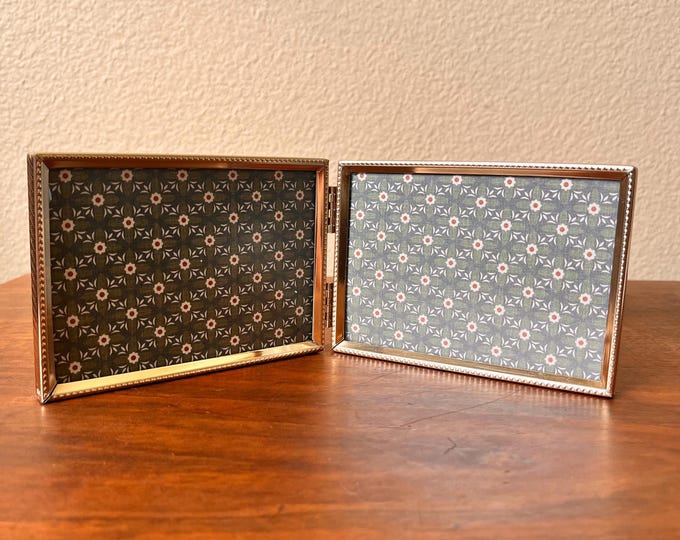 Vintage brass double 5x3 1/2 inch photo frame with ornate detailing holds a 3x5 image.detailing