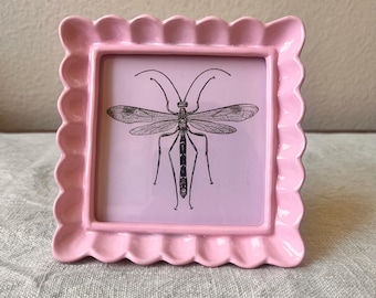 Vintage style pink colored 5 1/4” x 5 1/4” resin frame holda a 4”x4” photo