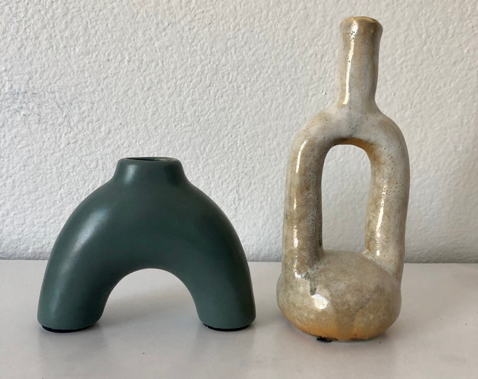 Abstract shaped bud vase comes in two styles blue and white