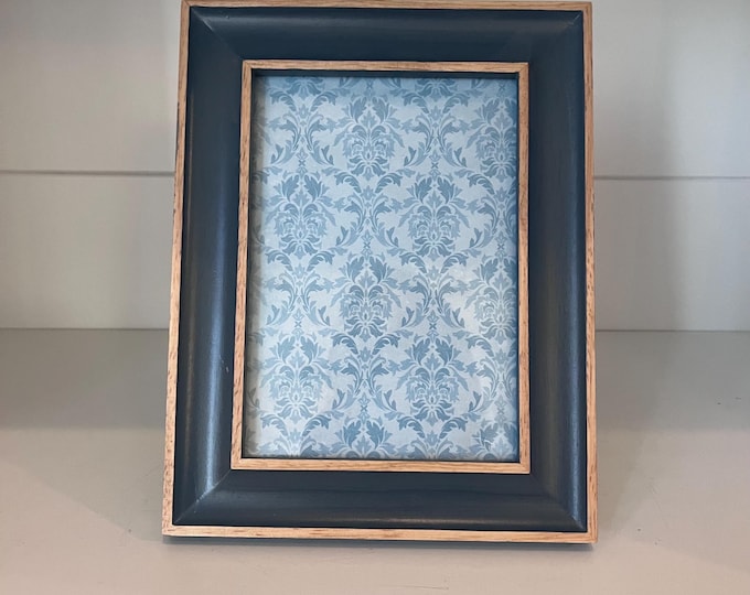 Vintage style blue frame with tan trim detail holds a 4 1/2"x6 1/2" image
